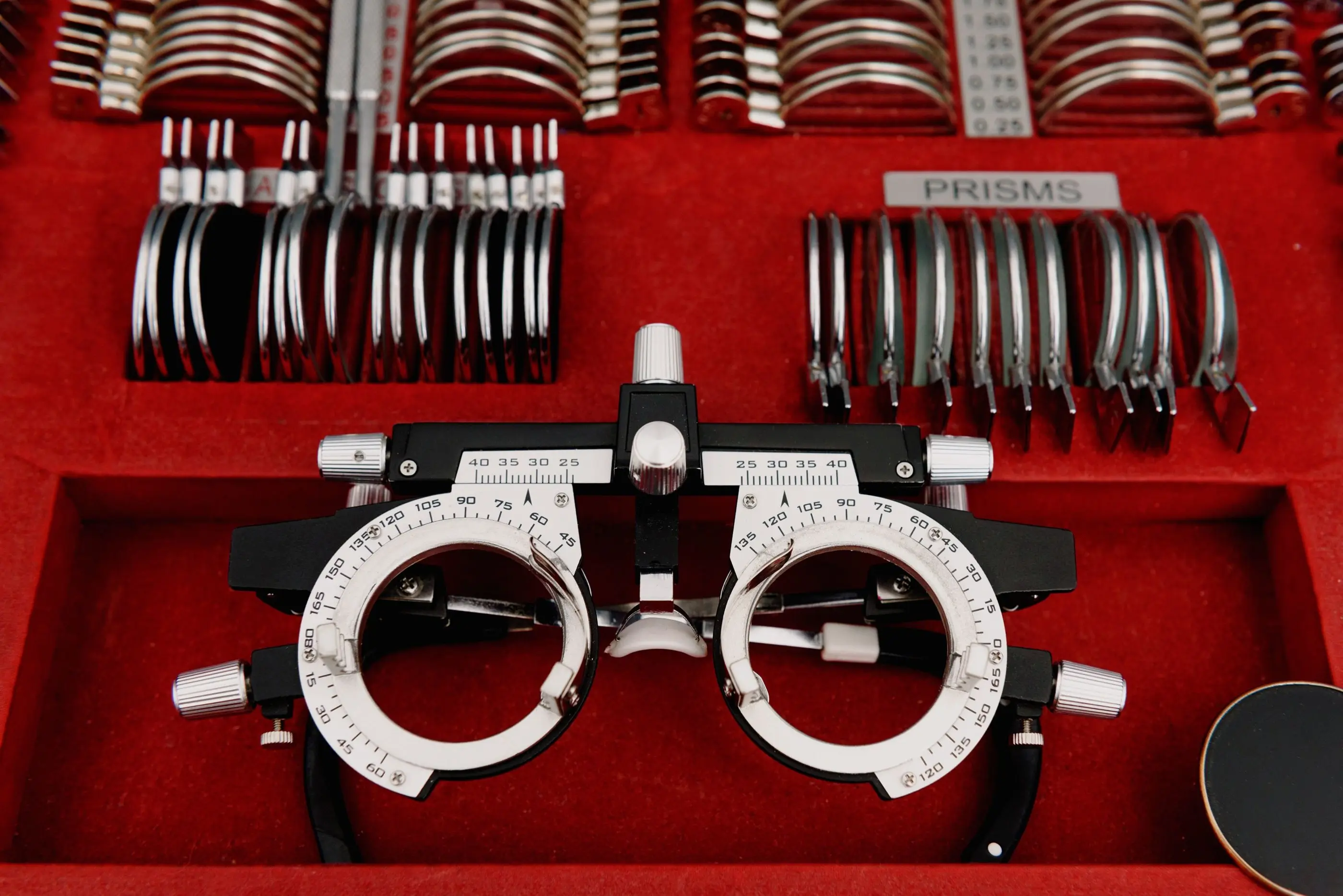 A trial frame resting in a case of trial lenses